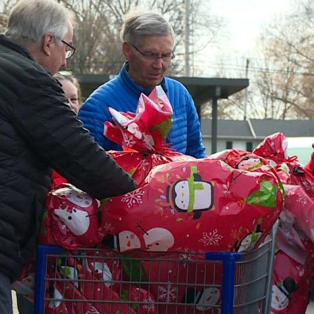 Volunteers handing out gifts during the VAC Holiday Program